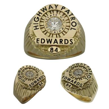 Custom Florida Highway Patrol Trooper badge ring in 14k gold with grooved side channels, black enamel, and a faceted center stone.